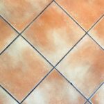 Fughe di piastrelle bianche trattate con acqua ossigenata per rimuovere macchie e ingiallimenti.