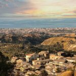 Panorama di un suggestivo paese siciliano, con stradine acciottolate e paesaggi mozzafiato.